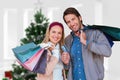 Composite image of smiling couple with shopping bags in front of window Royalty Free Stock Photo