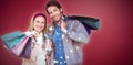 Composite image of smiling couple with shopping bags in front of window Royalty Free Stock Photo