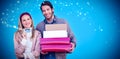 Composite image of smiling couple showing credit card and carrying boxes Royalty Free Stock Photo