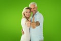 Composite image of smiling couple showing thumbs up together Royalty Free Stock Photo