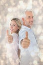 Composite image of smiling couple showing thumbs up together Royalty Free Stock Photo