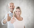 Composite image of smiling couple showing thumbs up together Royalty Free Stock Photo