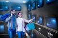 Composite image of smiling couple walking hand in hand and going window shopping Royalty Free Stock Photo