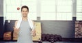 Composite image of smiling fit young man with apple and water bottle Royalty Free Stock Photo