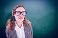 Composite image of smiling geeky hipster girl looking at something