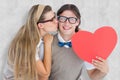 A Composite image of smiling geeky hipster and his girlfriend