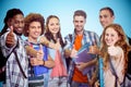 Composite image of smiling group of students doing thumbs up Royalty Free Stock Photo