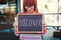 Composite image of smiling hipster woman holding blackboard Royalty Free Stock Photo