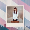 Composite image of smiling hipster woman holding suitcase Royalty Free Stock Photo