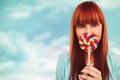 Composite image of smiling hipster woman with a lollipop Royalty Free Stock Photo