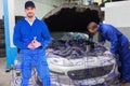 Composite image of smiling male mechanic holding spanner Royalty Free Stock Photo