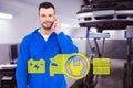 Composite image of smiling male mechanic using his mobile phone Royalty Free Stock Photo