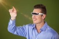 Composite image of smiling man pointing while using virtual video glasses Royalty Free Stock Photo