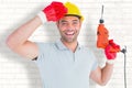 Composite image of smiling manual worker holding drill machine Royalty Free Stock Photo