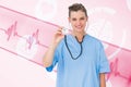 Composite image of smiling nurse using stethoscope Royalty Free Stock Photo