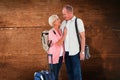 Composite image of smiling older couple going on their holidays Royalty Free Stock Photo