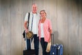 Composite image of smiling older couple going on their holidays Royalty Free Stock Photo