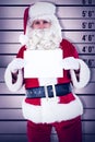 Composite image of smiling santa claus holding page Royalty Free Stock Photo