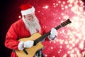 Composite image of smiling santa claus playing guitar Royalty Free Stock Photo