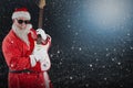 Composite image of smiling santa claus playing a guitar Royalty Free Stock Photo