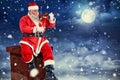Composite image of smiling santa claus playing violin on chair Royalty Free Stock Photo