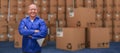 Composite image of smiling warehouse manager standing with arms crossed Royalty Free Stock Photo