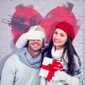 Composite image of smiling woman covering partners eyes and holding gift Royalty Free Stock Photo