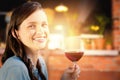 Composite image of smiling woman holding a glass of red wine Royalty Free Stock Photo