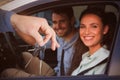 Composite image of smiling woman receiving keys from somebody Royalty Free Stock Photo