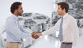 Composite image of smiling young businessmen shaking hands in office Royalty Free Stock Photo