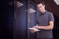 Composite image of smiling young man with tablet computer