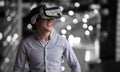 Composite image of smiling young man wearing virtual reality glasses Royalty Free Stock Photo