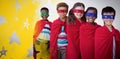Composite image of smilnig children in superhero costumes