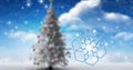 Composite image of snowflakes and christmas tree against cloudy sky with copy space Royalty Free Stock Photo