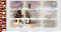 Composite image of snowflakes and house seen through window, copy space Royalty Free Stock Photo