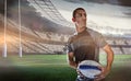 Composite image of sober rugby player holding ball