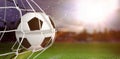 Composite image of soccer ball in goal net Royalty Free Stock Photo