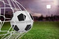 Composite image of soccer ball in goal net Royalty Free Stock Photo