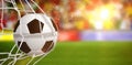 Composite image of soccer ball in goal net Royalty Free Stock Photo
