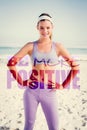 A Composite image of sporty blonde on the beach smiling at camera Royalty Free Stock Photo