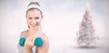 Composite image of sporty happy blonde lifting dumbbell on the beach Royalty Free Stock Photo