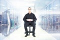 Composite image of stern businessman sitting on an office chair Royalty Free Stock Photo