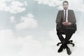 Composite image of stern businessman sitting on an office chair Royalty Free Stock Photo