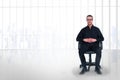 Composite image of stern businessman sitting on an office chair Royalty Free Stock Photo