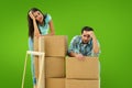 Composite image of stressed young couple with moving boxes