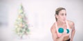 Composite image of strong woman doing bicep curl with blue dumbbell Royalty Free Stock Photo