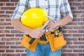 Composite image of technician holding hammer and hard hat Royalty Free Stock Photo