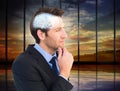 Composite image of thinking businessman touching his chin Royalty Free Stock Photo