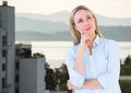 Composite image of thoughtful caucasian woman against cityscape in background Royalty Free Stock Photo