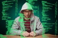 Composite image of thoughtful man with hooded shirt sitting at desk